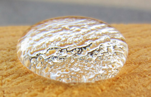 Bead of water on top of a piece of wood treated with AquaProof WB10